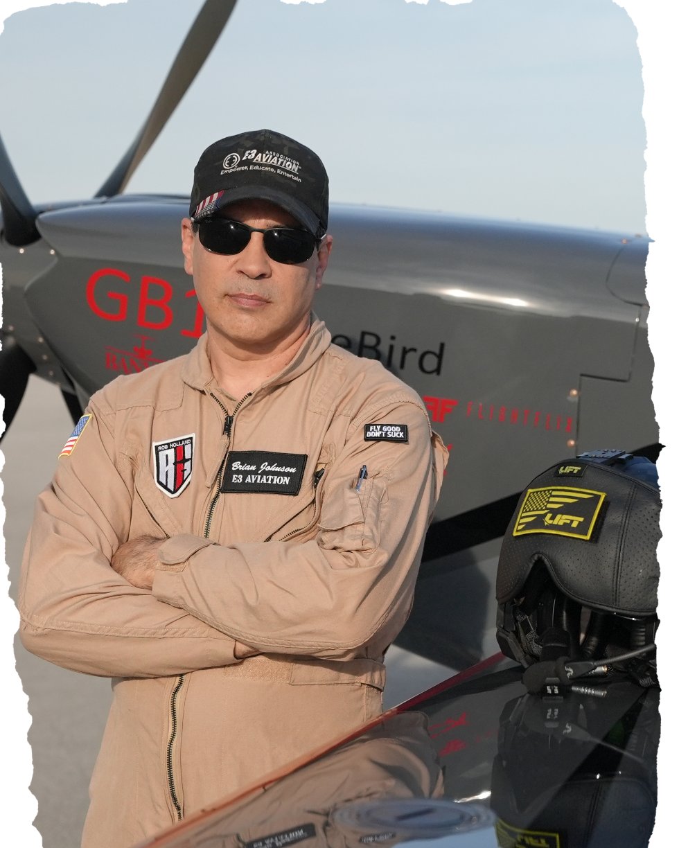 Brian Johnson, Founder & CEO of E3 Aviation, in an E3 Aviation flight suit beside his aircraft